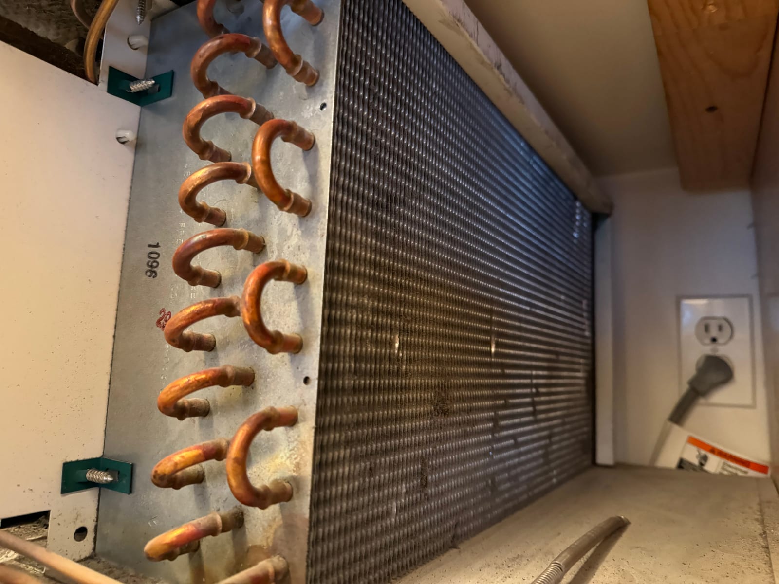 Dirty Sub-Zero condenser coil with dust buildup — frequent root cause behind 'failing compressor' calls